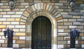 Liberty Street entrance flanked by fixtures crafted by metalworker Samuel Yellin. Yellin was awarded a commission to complete the wrought iron decorative work in 1920. Today the ironwork is priceless. (2001)