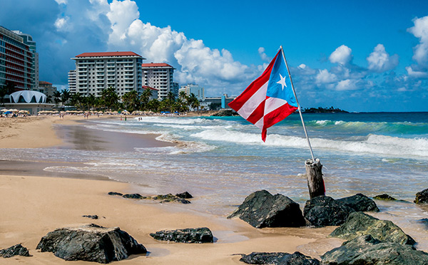 The flag of Puerto Rico blowing in the wind on a beach in San Juan, Puerto Rico