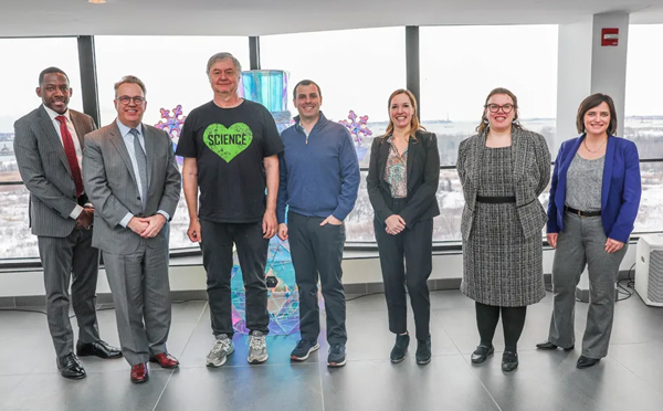 president williams standing with business leaders and staff