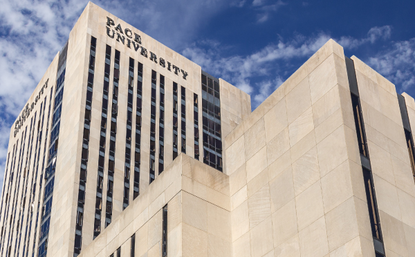Pace University building against a blue sky with wispy clouds. 