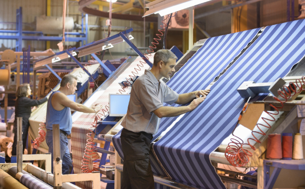 small business workers creating fabric products in shop 