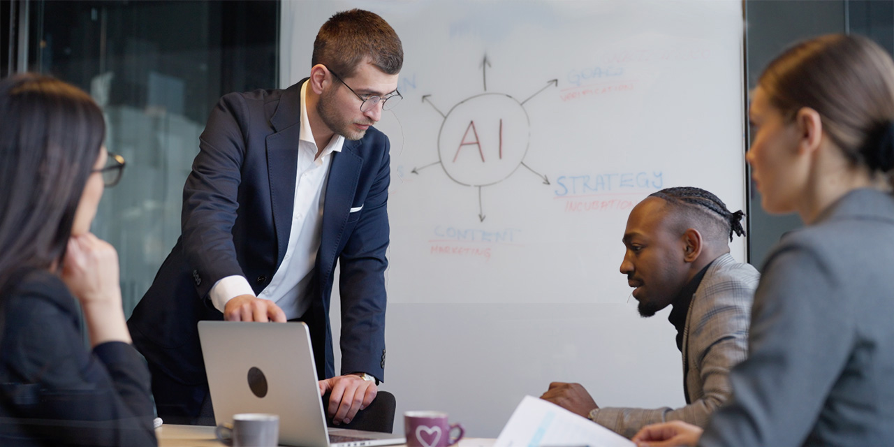 four professionals in discussion at a conference room table 