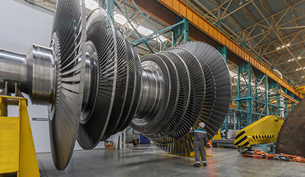Decorative Photo: Assembly of a steam turbine rotor in a plant workshop.