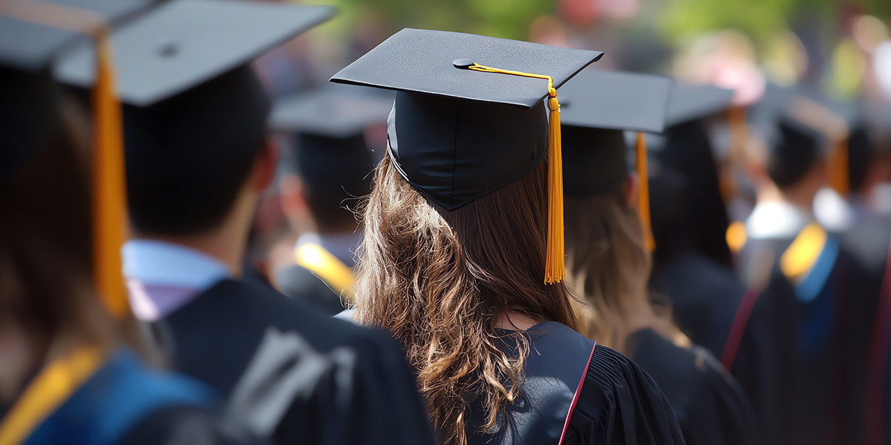 Image of back of college students in cap and gowns