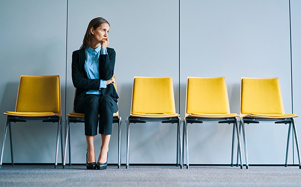 Female adult is focused on budgeting at kitchen table while child eats noodles, with groceries and bills visible, showcasing family financial management and daily life