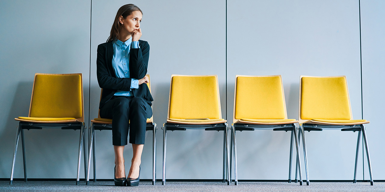 Female adult is focused on budgeting at kitchen table while child eats noodles, with groceries and bills visible, showcasing family financial management and daily life